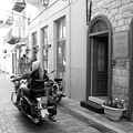 BW Girl Riding on Motorcycle with Handsome Bike Rider Speed Stone Paved Street Nafplion Greece